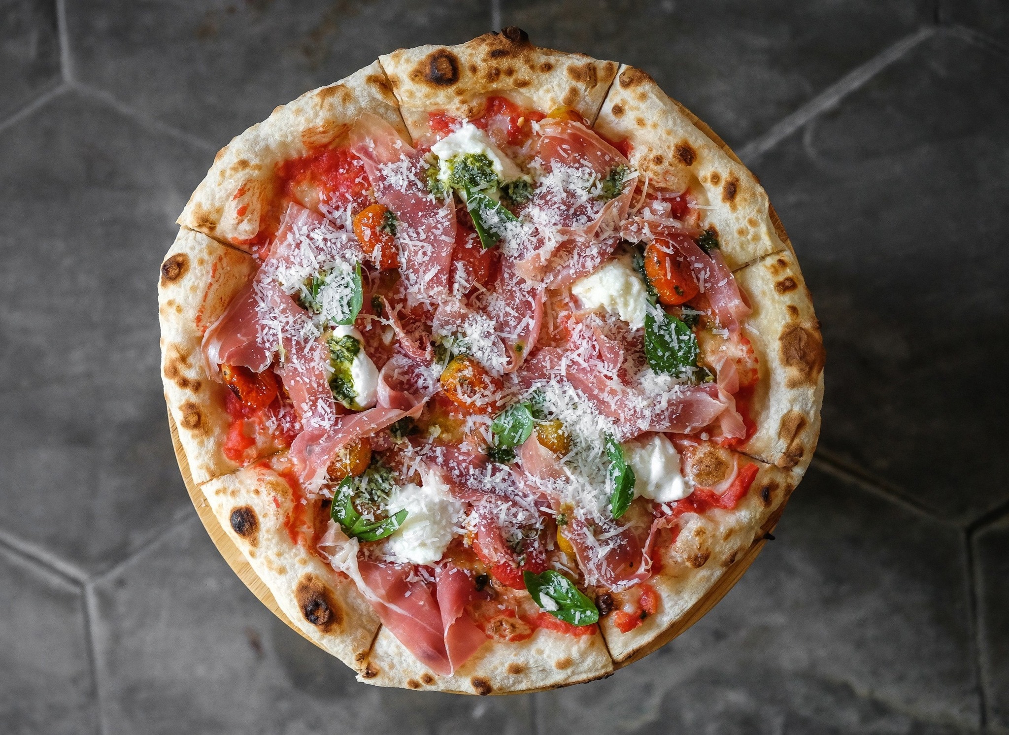 Lim Dining Room serves thin-crust Italian-style pizzas topped with fresh ingredients and rich cheeses